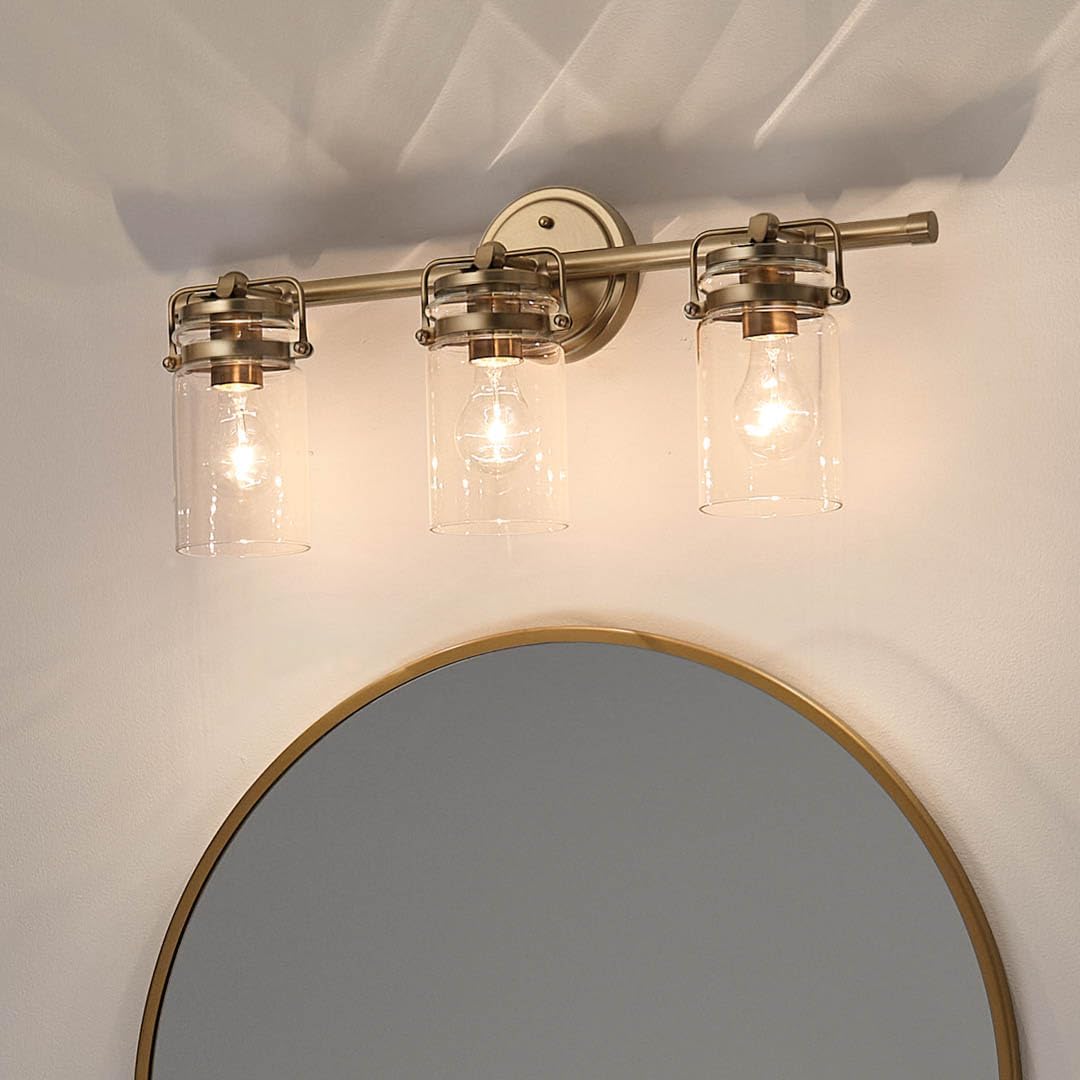 Kichler Brinley 24" 3-Light Bathroom Vanity Light Fixture with Clear Glass in Champagne Bronze, Modern Farmhouse Mason Jar Style for Mirror Lighting (24" W x 10.25" H), 45689CPZ