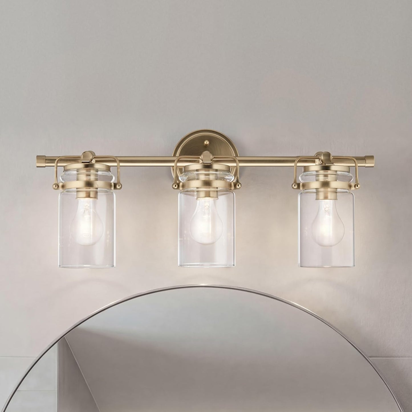 Kichler Brinley 24" 3-Light Bathroom Vanity Light Fixture with Clear Glass in Champagne Bronze, Modern Farmhouse Mason Jar Style for Mirror Lighting (24" W x 10.25" H), 45689CPZ