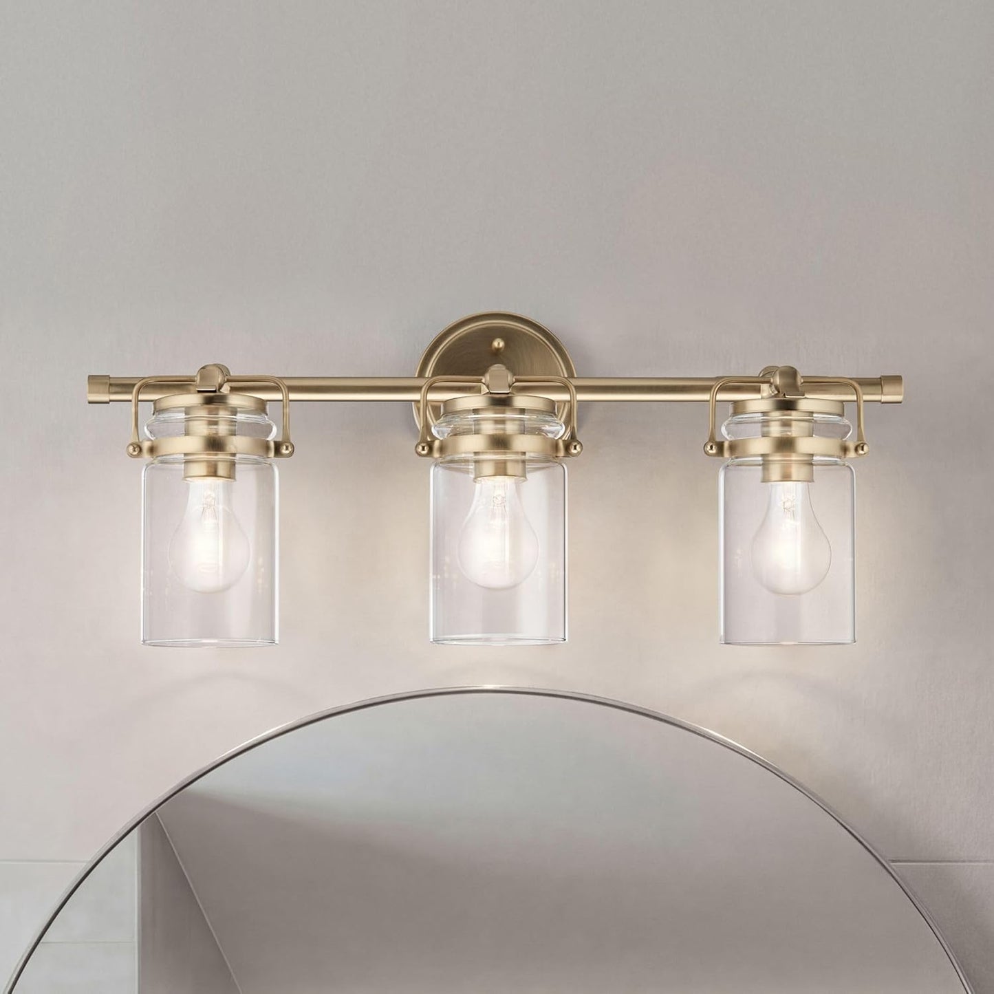 Kichler Brinley 24" 3-Light Bathroom Vanity Light Fixture with Clear Glass in Champagne Bronze, Modern Farmhouse Mason Jar Style for Mirror Lighting (24" W x 10.25" H), 45689CPZ